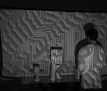 Photograph of image projection over 3D massing model of a small tower